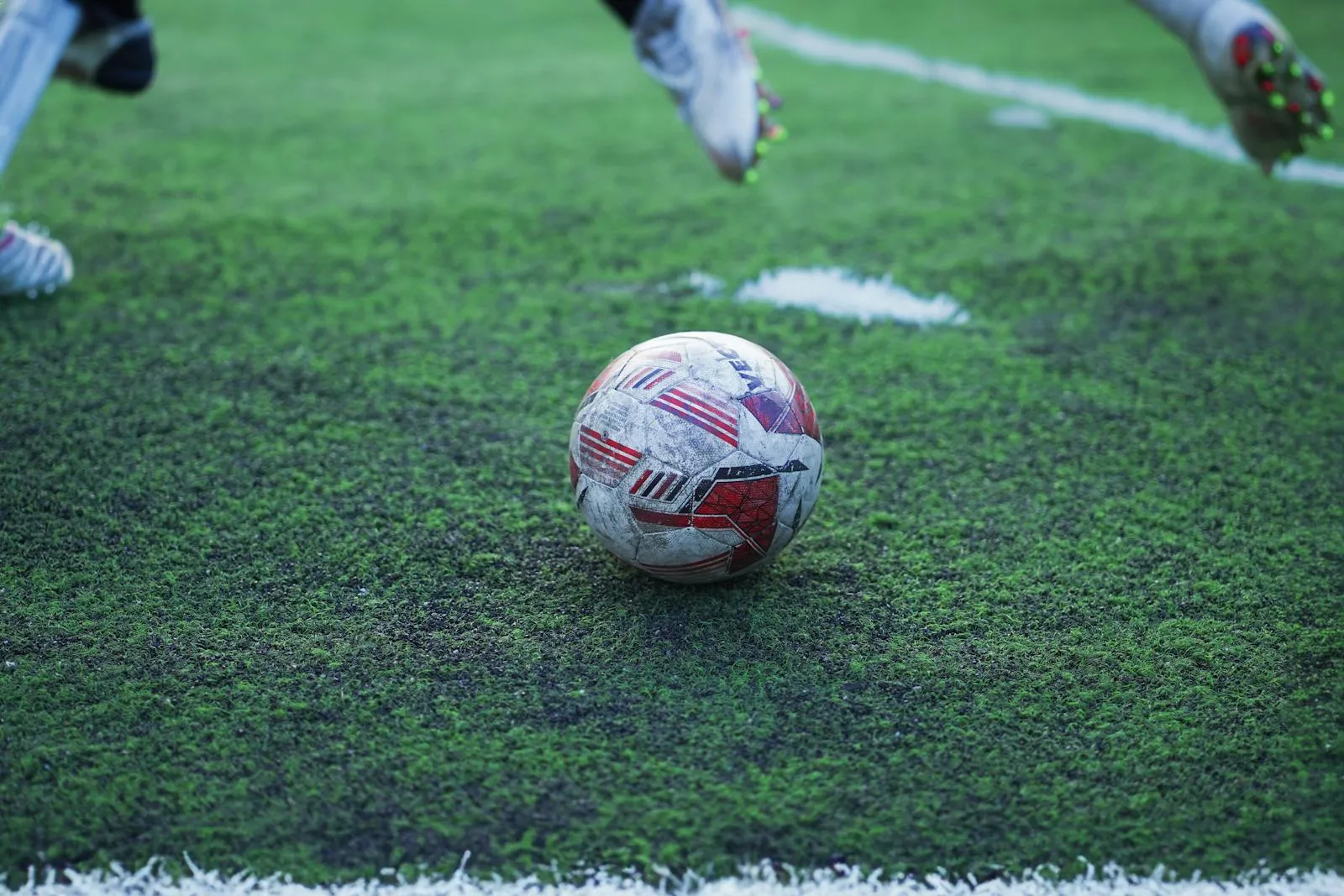 A football rests on wet grass under stadium floodlights — France's transition game at the 2026 World Cup