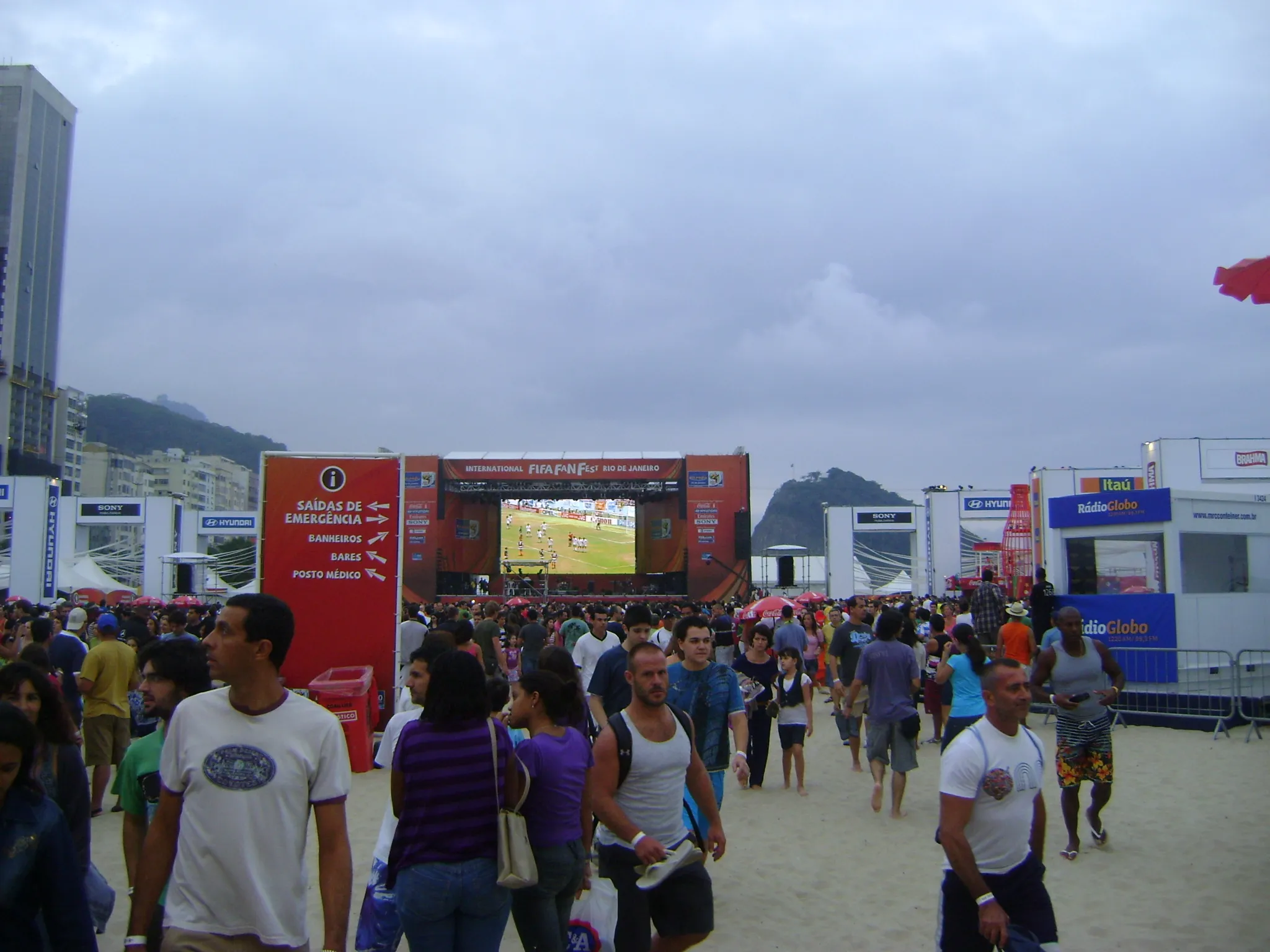 FIFA Fan Festival crowd at Rio de Janeiro Copacabana Beach during the 2014 World Cup — free public viewing returns to all 16 host cities for the 2026 FIFA World Cup across USA, Mexico and Canada