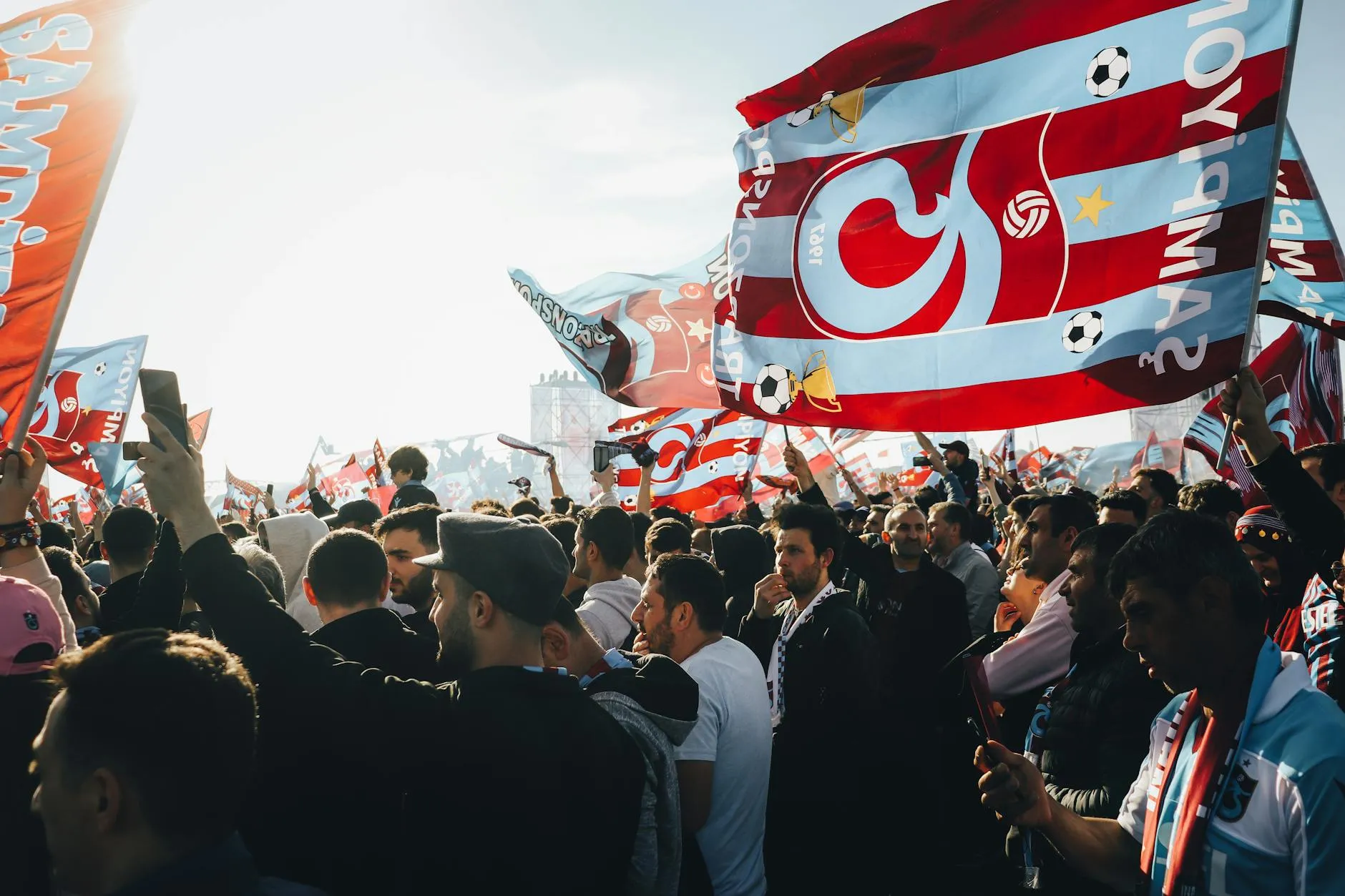 Football fans waving colourful flags — World Cup 2026 in Mexico airs 32 matches free on TV Azteca and Televisa's open channels, with all 104 on ViX