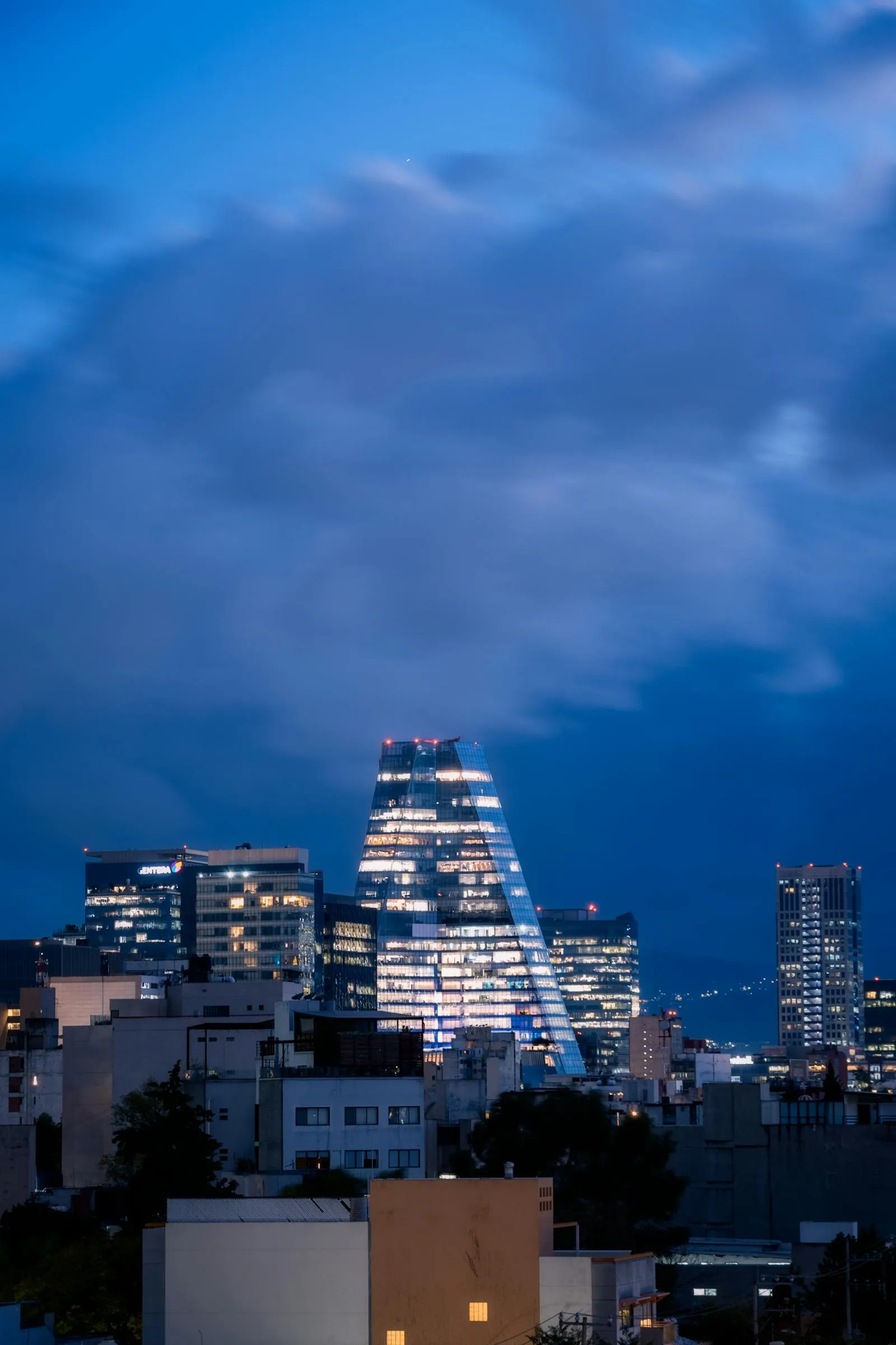 Mexico City skyline at blue hour during World Cup 2026 — the capital's Cultural Corridor runs 19 football-themed exhibitions across 17 museums and landmarks, including Museo Jumex, the Franz Mayer Museum, the National Museum of Anthropology and Museo Tamayo, through the tournament window