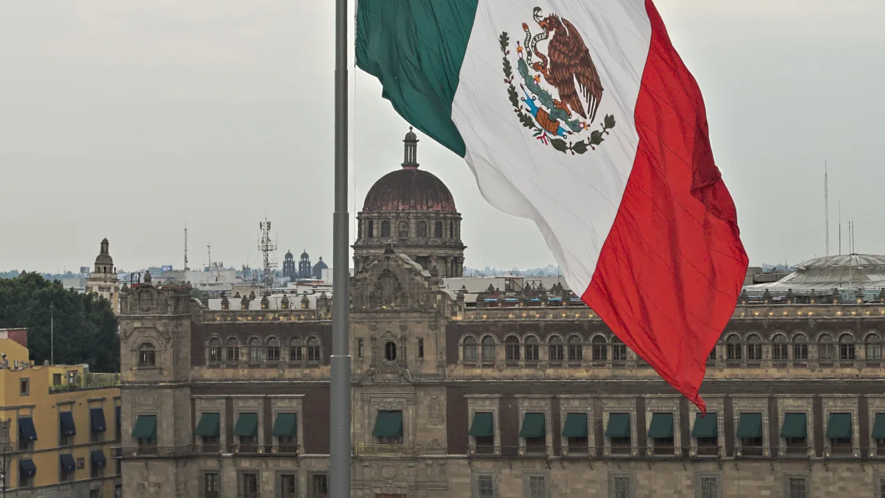 El Zócalo (Plaza de la Constitución) in Mexico City's Centro Histórico at dusk — the colonial square that hosts the official FIFA Fan Festival for World Cup 2026 from Thursday June 11 through Sunday July 19, with 80,000+ capacity, giant screens for every tournament match, and the Metropolitan Cathedral and National Palace flanking the gathering