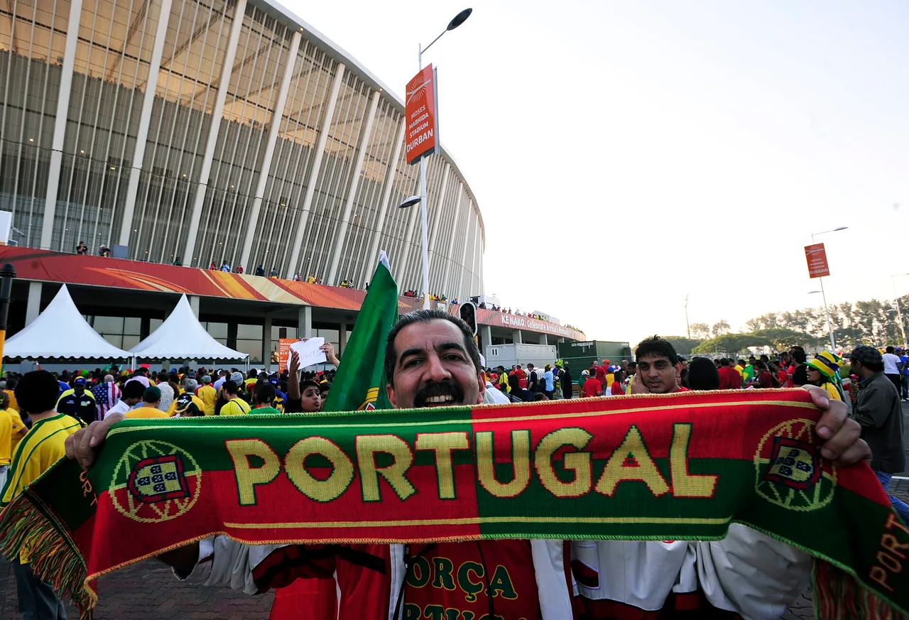 Portugal supporters in red and green wave flags at a World Cup match, evoking Portugal's 2-1 Round of 32 win over Croatia in Toronto on July 2