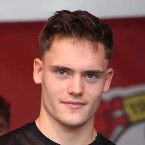 Florian Wirtz in Germany's 2026 World Cup home kit. Adidas's final Germany shirt features a white base with a tricolour diamond and chevron pattern in black red and gold paying tribute to the 1990 and 2014 World Cup-winning designs, the last of a 70-year Adidas DFB partnership before Nike takes over in 2027